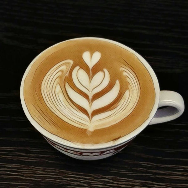 Cappuccino decorato da Matteo Beluffi con disegno di foglia realizzato in latte art.